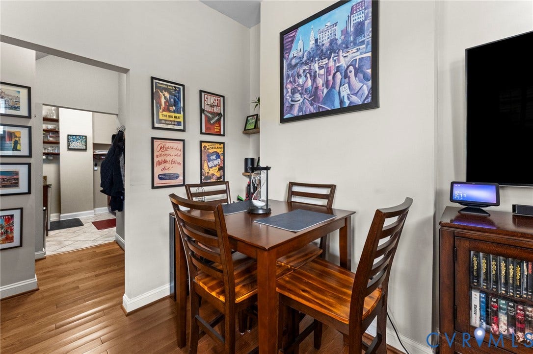Hardwood-finish flooring throughout, light neutral wall paint, and a built-in wall shelf