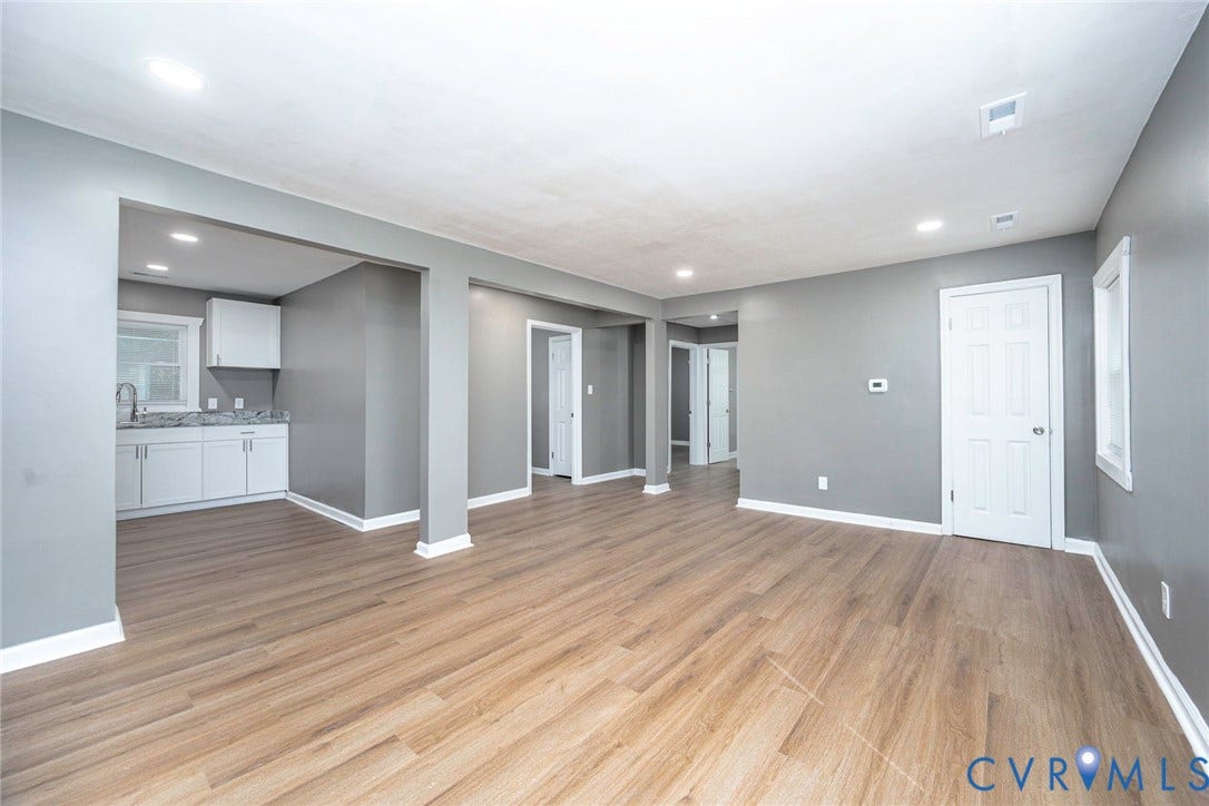 634 Fayette Avenue, Richmond, VA 23222 Open concept living space featuring wood-finish flooring, recessed lighting, and a kitchen area with white cabinetry and light-toned countertops