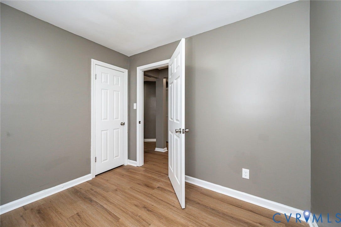 634 Fayette Avenue, Richmond, VA 23222 Gray painted walls, wood-finish flooring, white trim, and paneled doors