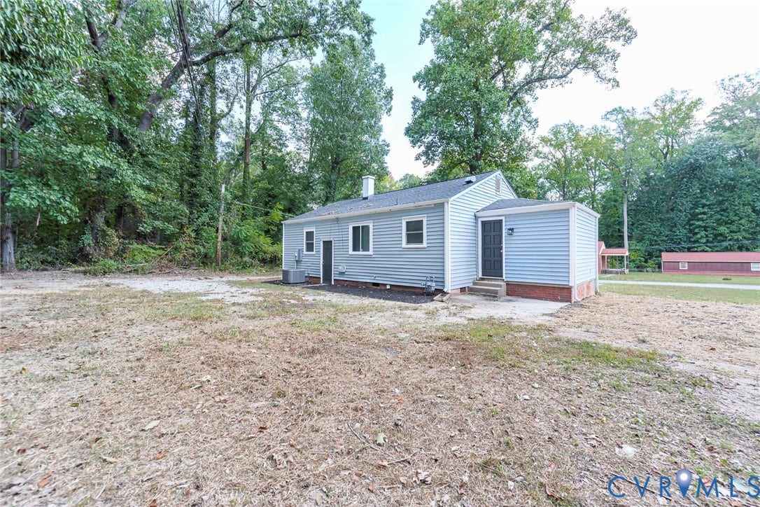 634 Fayette Avenue, Richmond, VA 23222 Light blue siding exterior with white trim windows and a dark entry door
