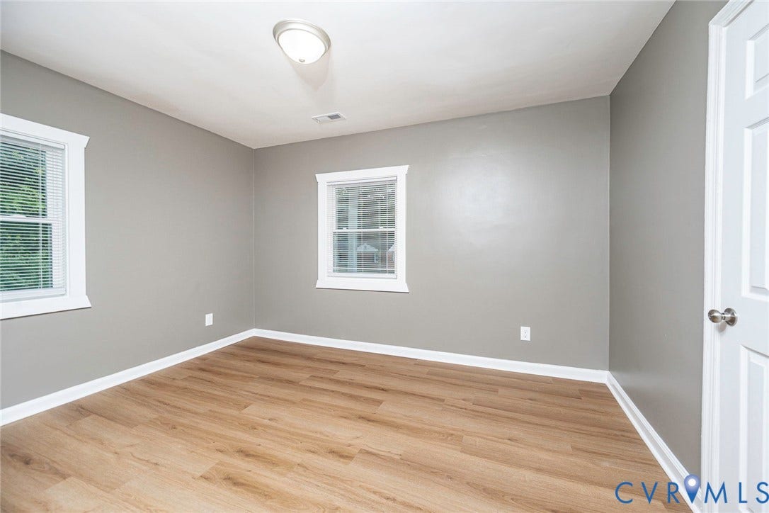 634 Fayette Avenue, Richmond, VA 23222 Wood-finish flooring, multiple windows with blinds, and neutral wall tones
