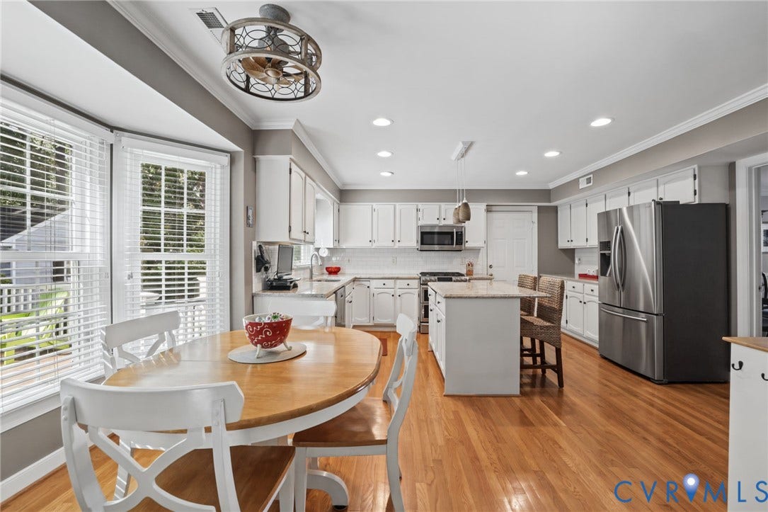 Featuring hardwood flooring and built-out Bay window