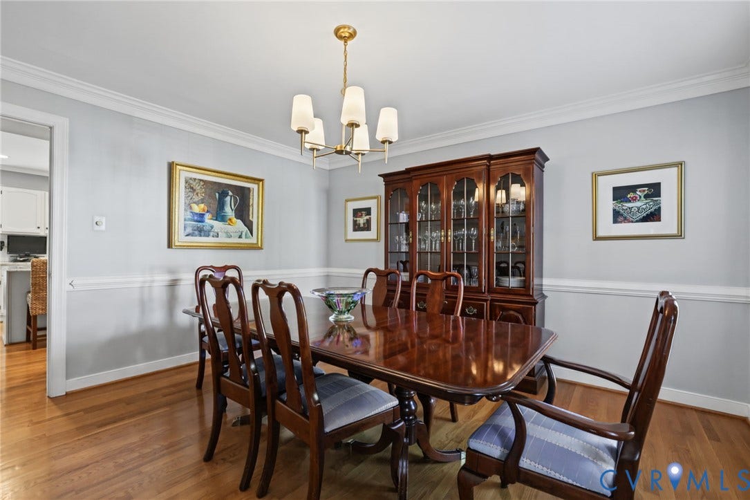 Chair rail molding, and a brass-finish chandelier