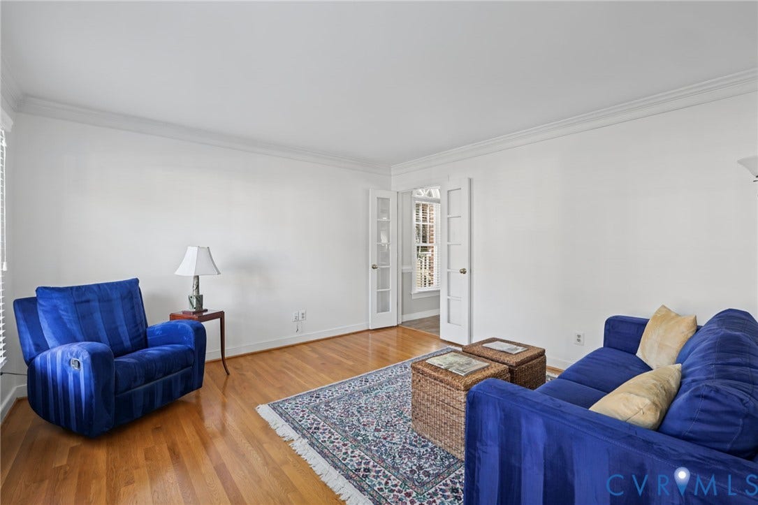Hardwood flooring, white walls, crown molding, and double French doors with glass panels