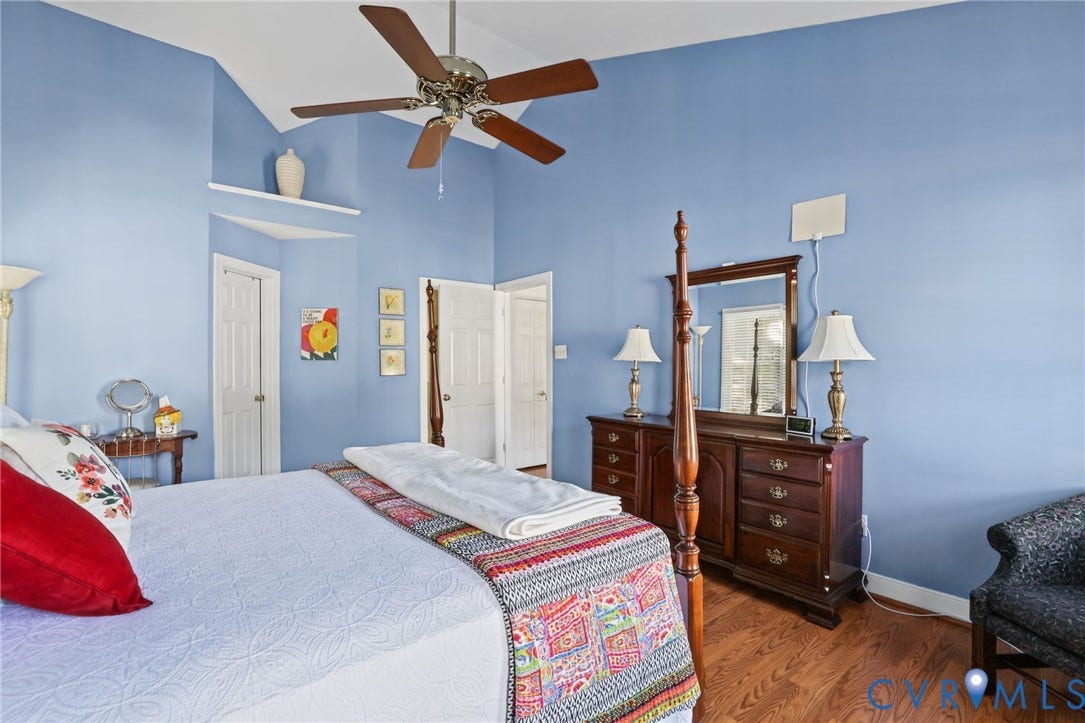 Vaulted ceiling with a ceiling fan.