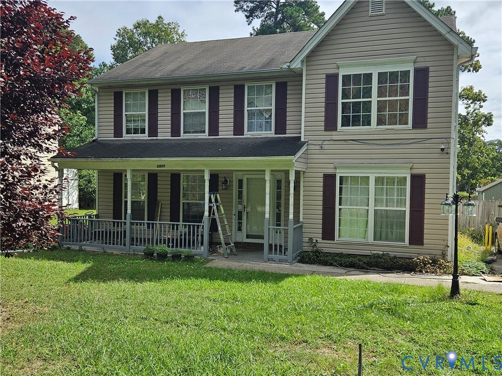 1307 Spruance Road, Outten Woods, Richmond, VA 23225 Two-story exterior with light-colored siding, contrasting dark shutters, and a covered front porch featuring a railing