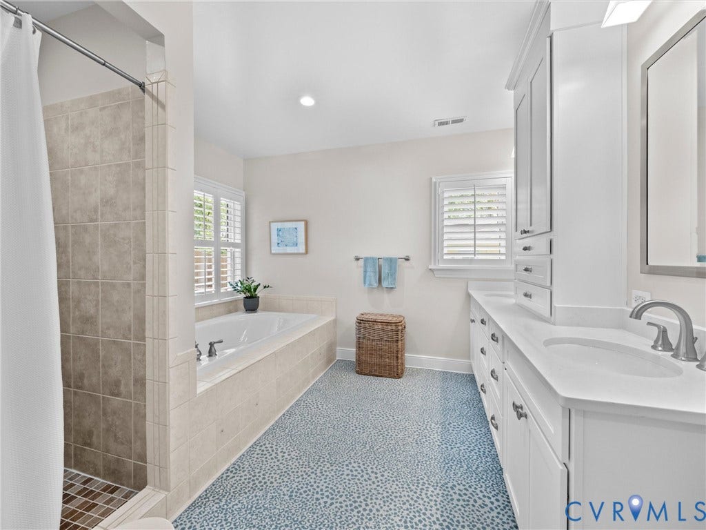 7723 Stuart Hall Road, Rollingwood Terrace, Henrico, VA 23229 Tile-surround soaking tub, dual vanity with white cabinetry, tile shower with mosaic floor, window with plantation shutters, and recessed lighting
