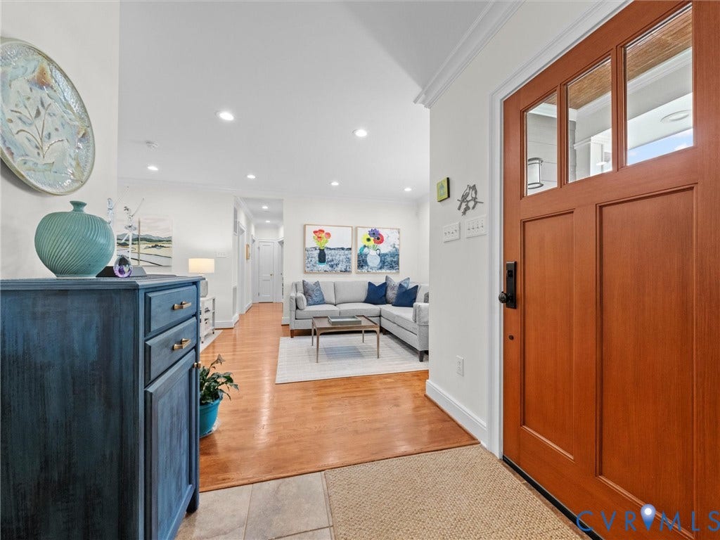 7723 Stuart Hall Road, Rollingwood Terrace, Henrico, VA 23229 Paneled wood entry door with clear glass lites and dark hardware, light tile flooring, wood-finish flooring, recessed lighting, and white crown molding