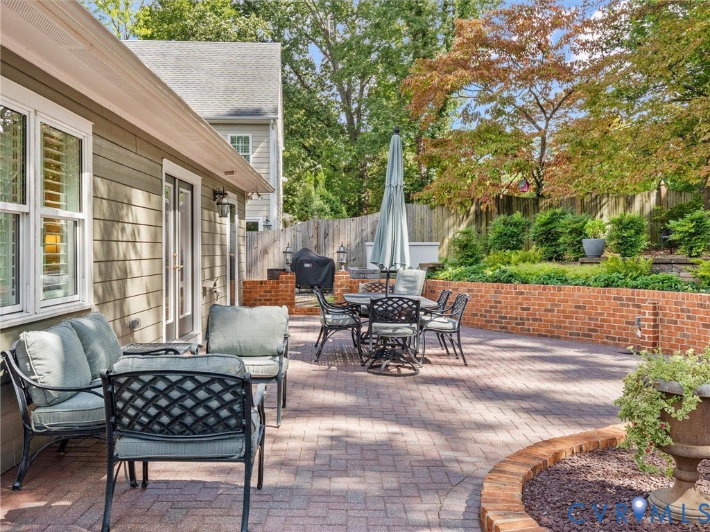 7723 Stuart Hall Road, Rollingwood Terrace, Henrico, VA 23229 Expansive brick paver patio featuring a raised brick planter and surrounding mature trees
