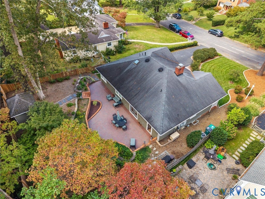 7723 Stuart Hall Road, Rollingwood Terrace, Henrico, VA 23229 Expansive brick patio, established landscaping, privacy fencing, and a detached shed structure