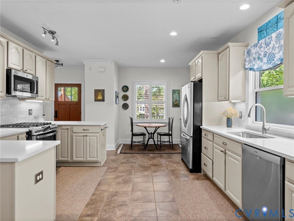 7723 Stuart Hall Road, Rollingwood Terrace, Henrico, VA 23229 White shaker-style cabinetry with chrome hardware, stainless steel appliances, white countertops, tile backsplash, and recessed lighting