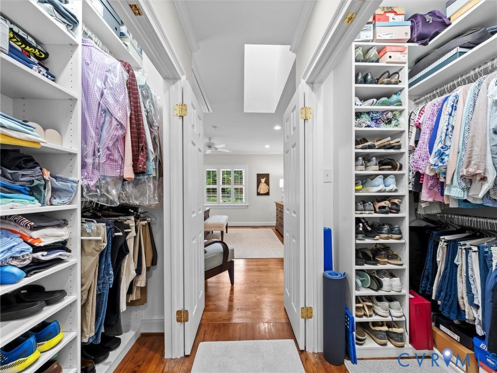 7723 Stuart Hall Road, Rollingwood Terrace, Henrico, VA 23229 Custom closet system with white shelving, multiple hanging rods, dedicated shoe storage, and wood-finish flooring