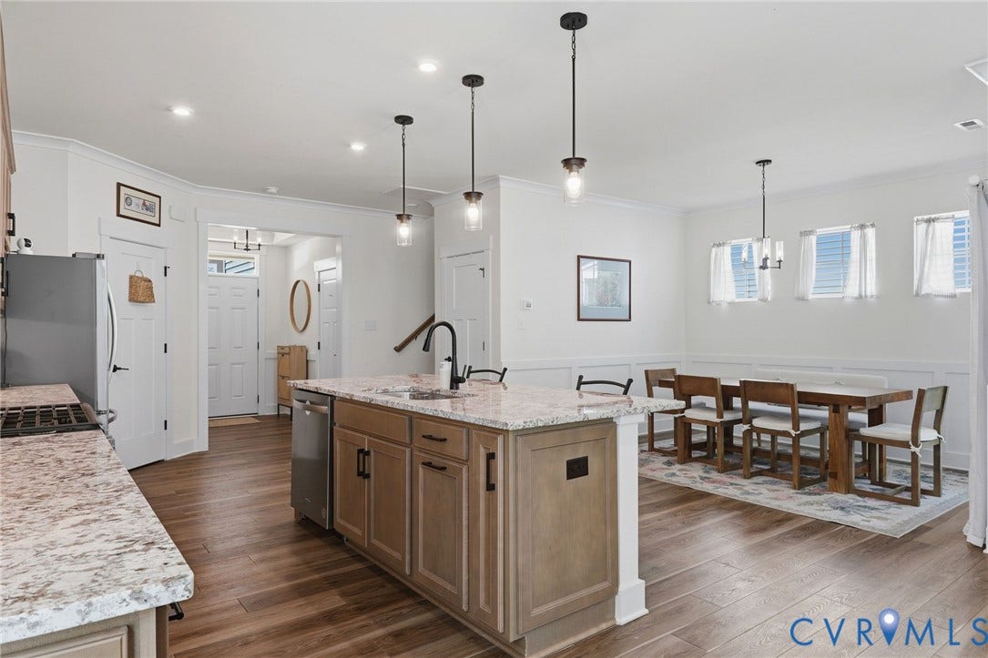6142 Jackline Run, Watermark, Chesterfield, VA 23234 Open-concept living space with wood-finish flooring, recessed lighting, and a kitchen island featuring a light-toned countertop