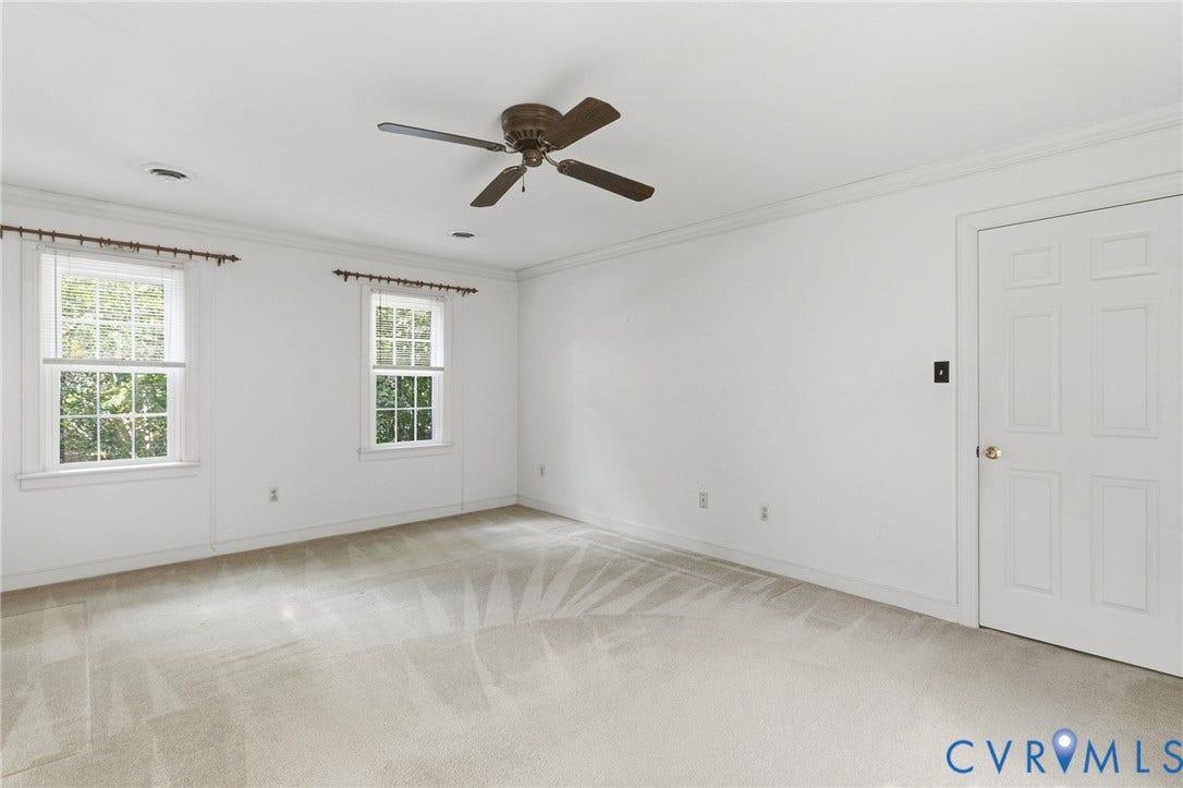 Recessed lighting, crown molding, double-pane windows, ceiling fan, and paneled door