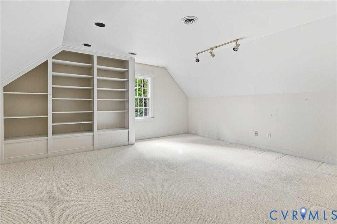 Built-in shelving, recessed ceiling lights, track lighting, and a window