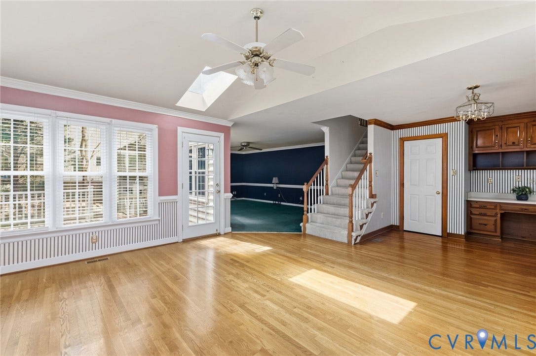 Hardwood flooring, triple windows, glass-paned door, skylight, and a built-in desk with cabinetry
