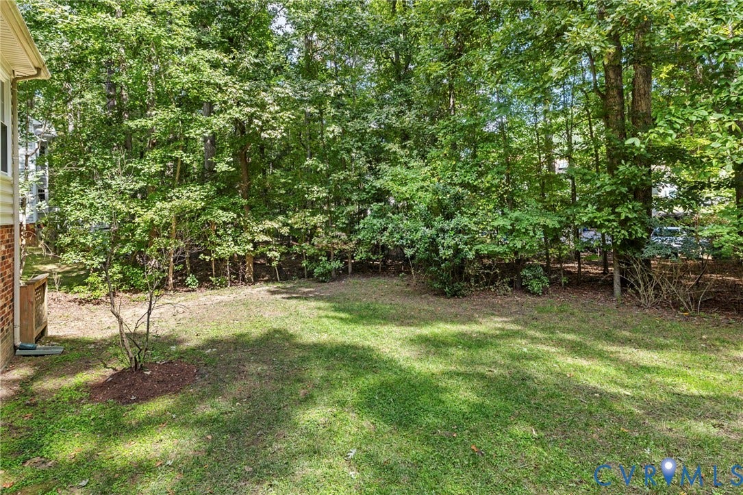 Expansive lawn area bordered by mature trees