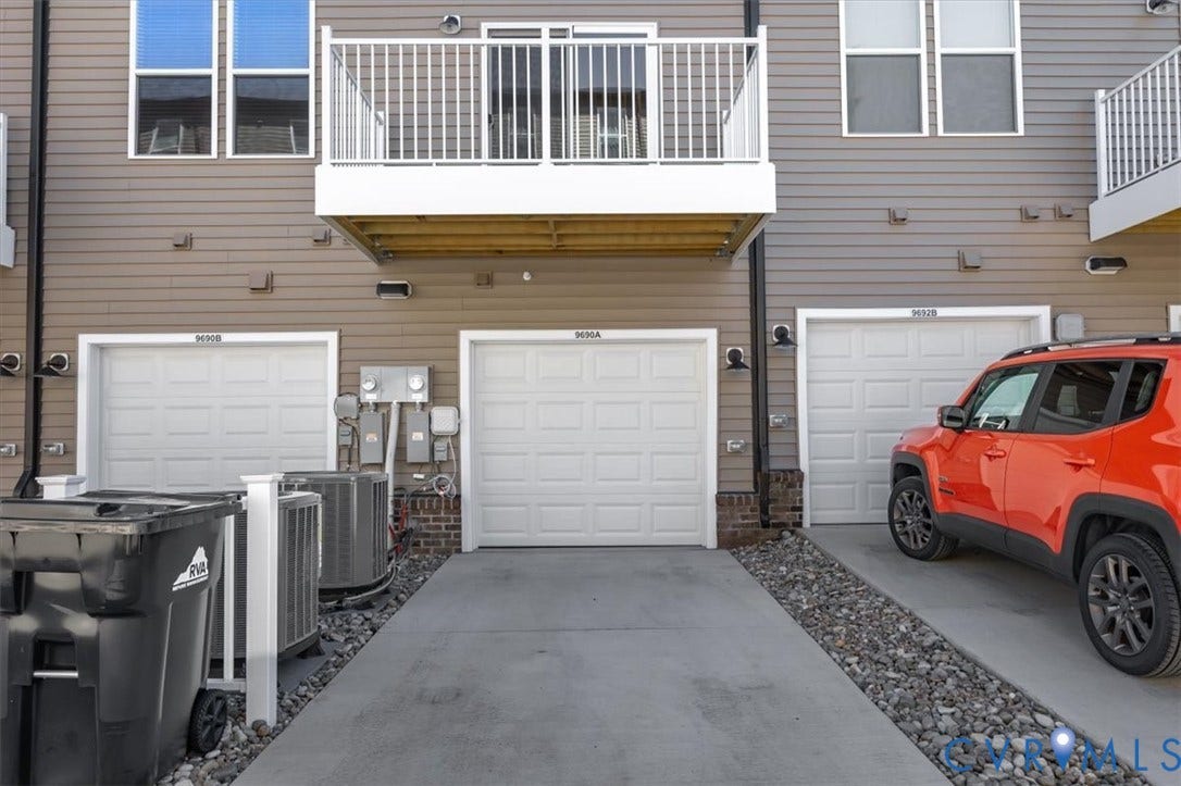 9690 Turning Point Dr, #A, 4E300, Glen Allen, VA 23059 Rear entry garage, a private balcony with white railings, and horizontal siding