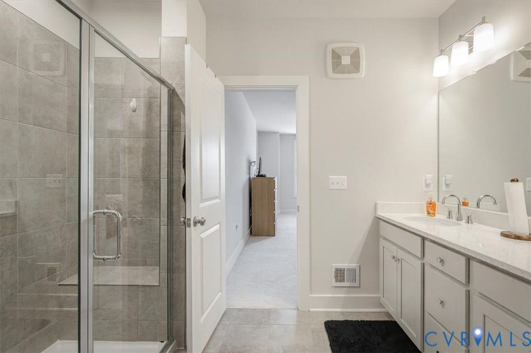 9690 Turning Point Dr, #A, 4E300, Glen Allen, VA 23059 Spacious bathroom featuring a glass-enclosed shower with a built-in bench, a single vanity with a white countertop, and contemporary lighting