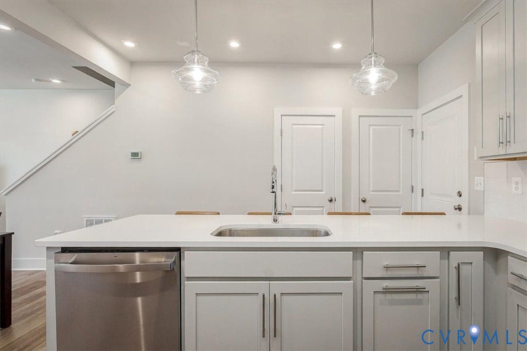 9690 Turning Point Dr, #A, 4E300, Glen Allen, VA 23059 Kitchen island with white countertop and integrated stainless steel sink