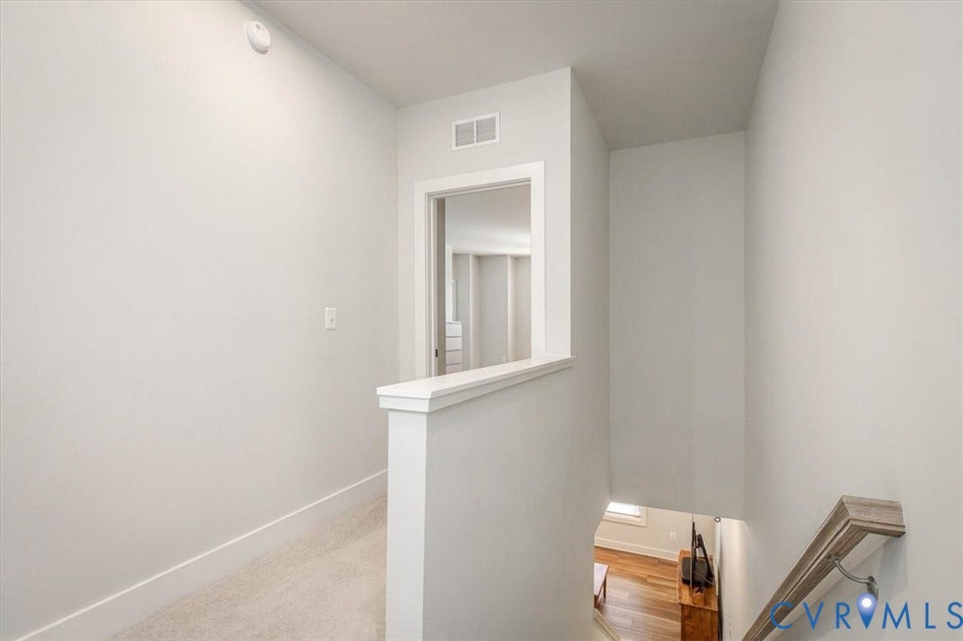 9690 Turning Point Dr, #A, 4E300, Glen Allen, VA 23059 Upper-level landing with neutral carpeting, white wall finishes, and a framed opening