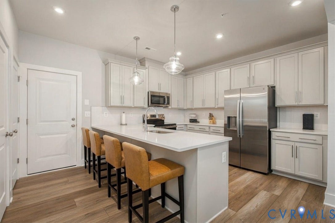 9690 Turning Point Dr, #A, 4E300, Glen Allen, VA 23059 Kitchen featuring wood-finish flooring, an island with solid surface countertops, recessed lighting, and stainless steel appliances