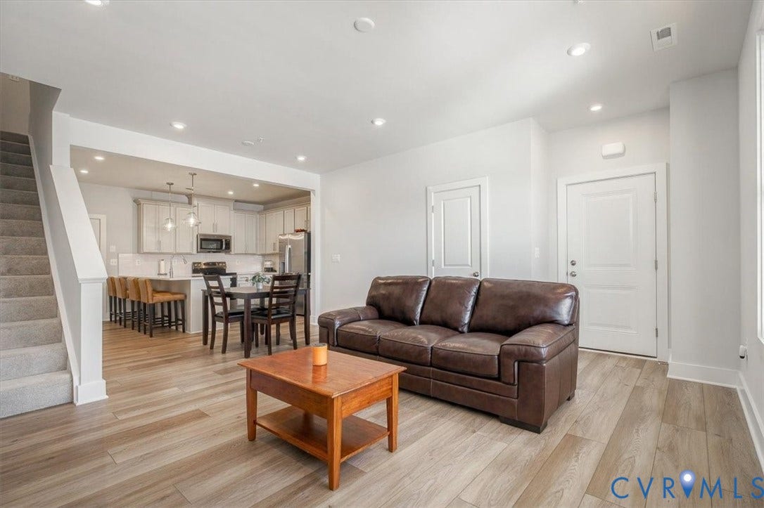 9690 Turning Point Dr, #A, 4E300, Glen Allen, VA 23059 Open-concept living space featuring wood-finish flooring, recessed lighting, and a modern kitchen with stainless steel appliances and white cabinetry