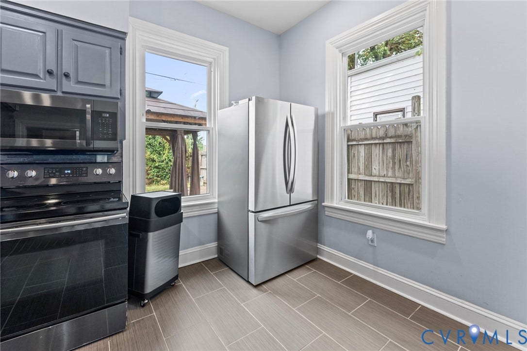 724 N 1st Street, Jackson Ward, Richmond, VA 23219 Stainless steel appliances, gray cabinetry with black hardware, wood-finish tile flooring, and white trim