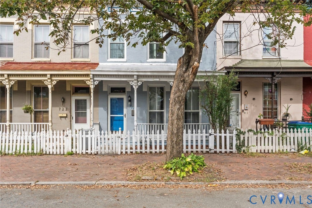 724 N 1st Street, Jackson Ward, Richmond, VA 23219 Two-story row home with a light blue exterior and white trim