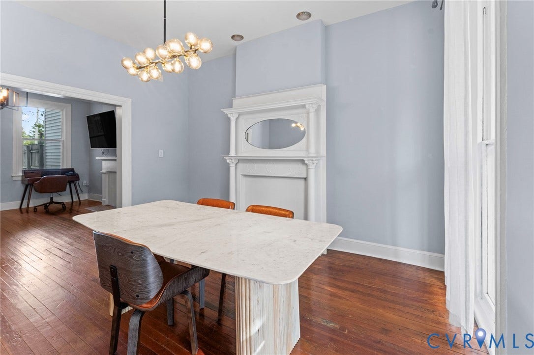 724 N 1st Street, Jackson Ward, Richmond, VA 23219 Hardwood flooring, recessed lighting, decorative fireplace with mantel, modern chandelier, and an open doorway
