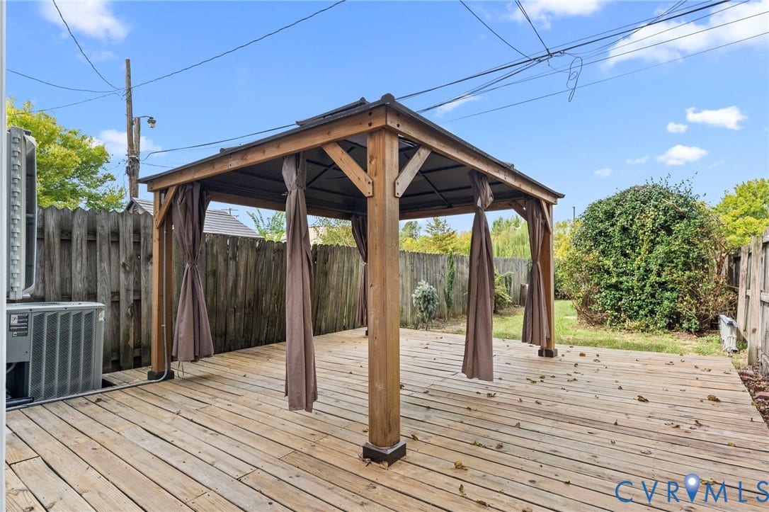 724 N 1st Street, Jackson Ward, Richmond, VA 23219 Expansive wood-finish decking featuring a built-in wooden gazebo with fabric drapes