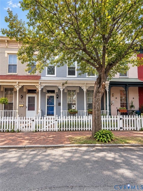 724 N 1st Street, Jackson Ward, Richmond, VA 23219 Brick pedestrian pathway, white picket fencing, and ornate porch detailing