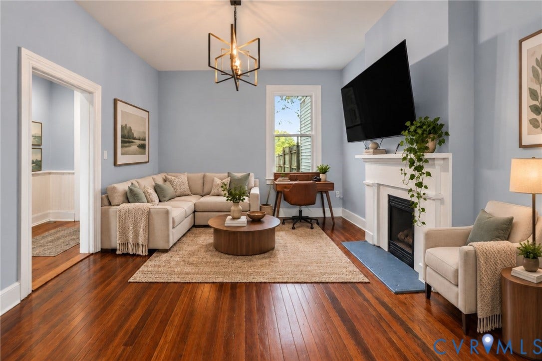 724 N 1st Street, Jackson Ward, Richmond, VA 23219 Hardwood flooring, painted walls, white trim, single window, and a built-in fireplace with a white mantel