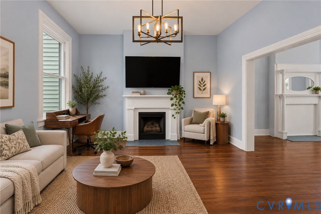 724 N 1st Street, Jackson Ward, Richmond, VA 23219 Hardwood flooring throughout, a decorative fireplace with a white mantel, and a modern chandelier
