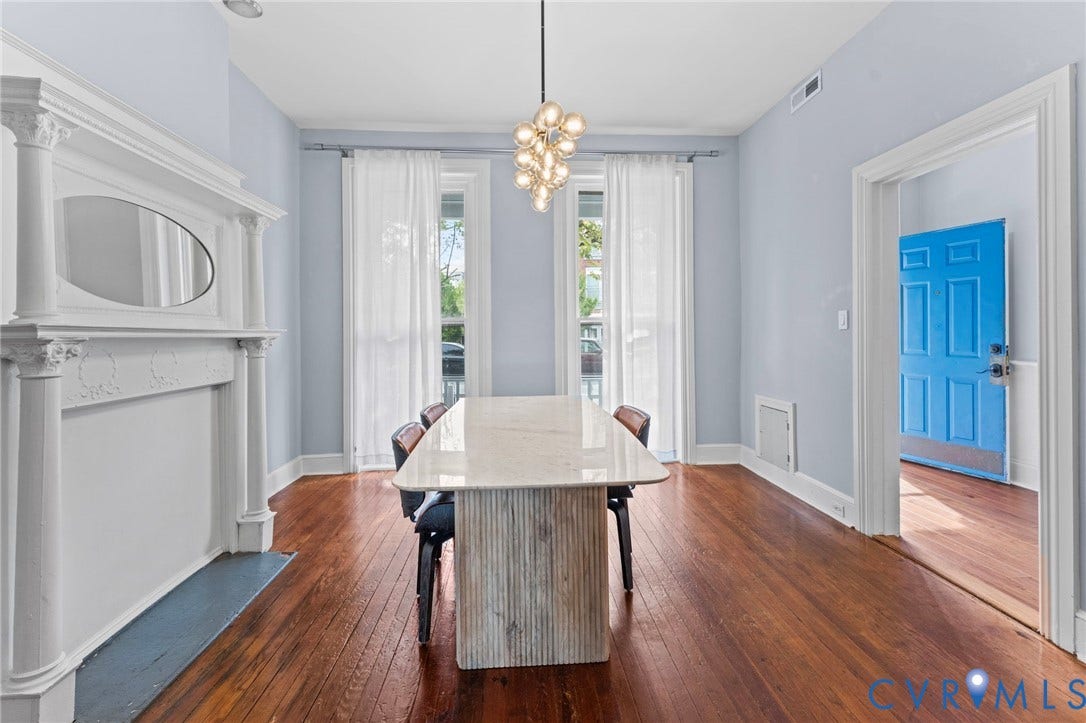 724 N 1st Street, Jackson Ward, Richmond, VA 23219 Hardwood flooring, decorative fireplace, white trim, recessed lighting, and a modern chandelier