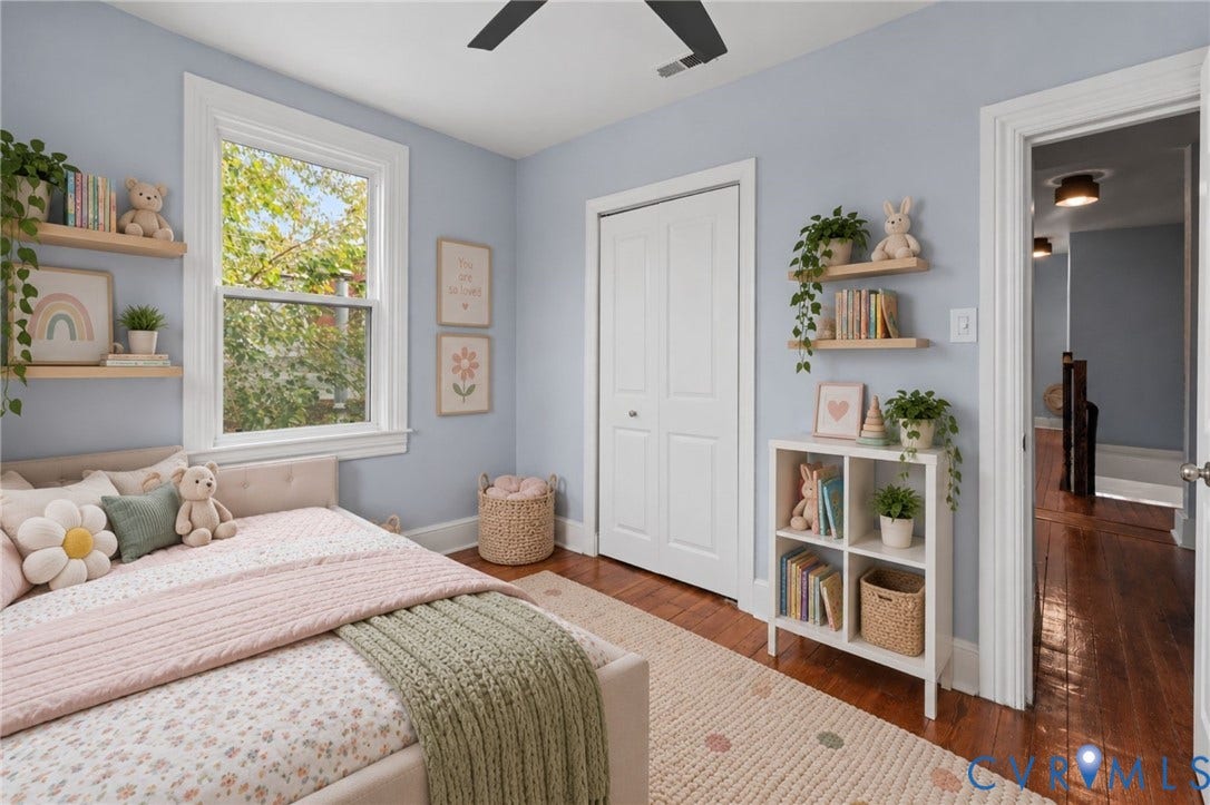 724 N 1st Street, Jackson Ward, Richmond, VA 23219 Hardwood flooring, natural light through a large window, built-in closet with bi-fold doors, ceiling fan, and floating wall shelves