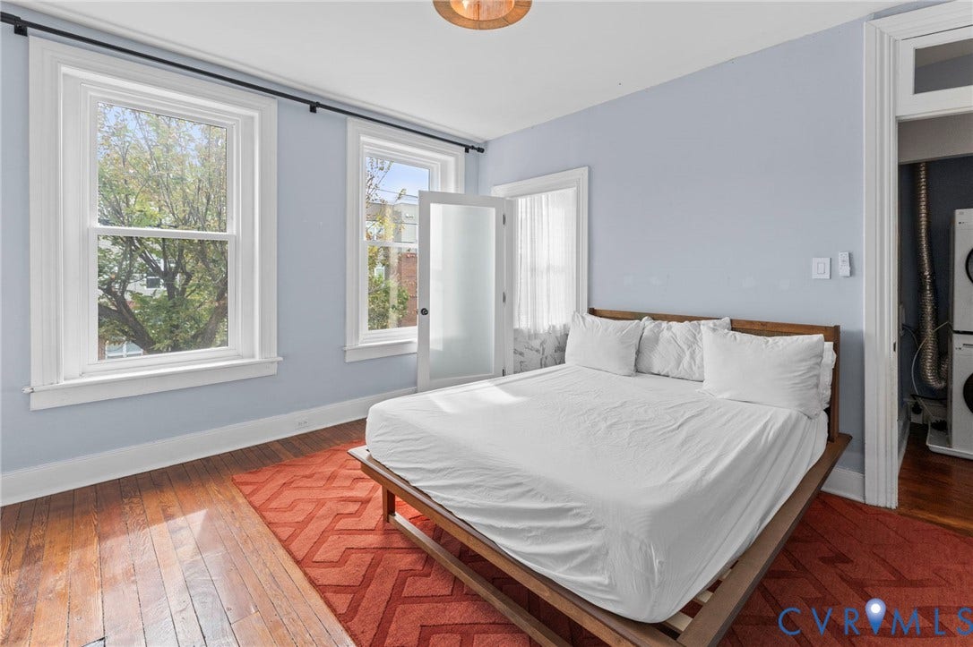 724 N 1st Street, Jackson Ward, Richmond, VA 23219 Hardwood flooring, dual sash windows, and light blue wall color
