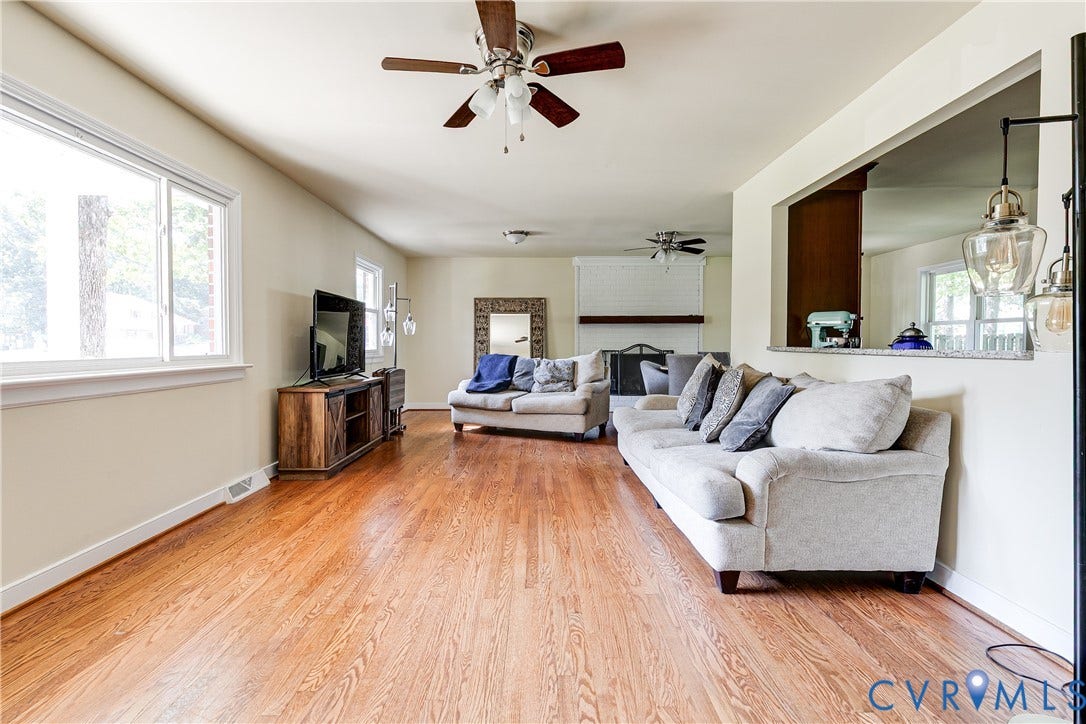 Hardwood flooring, recessed lighting, ceiling fan, and a pass-through opening