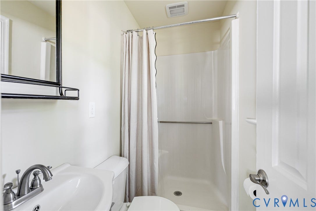 White porcelain sink with brushed nickel faucet