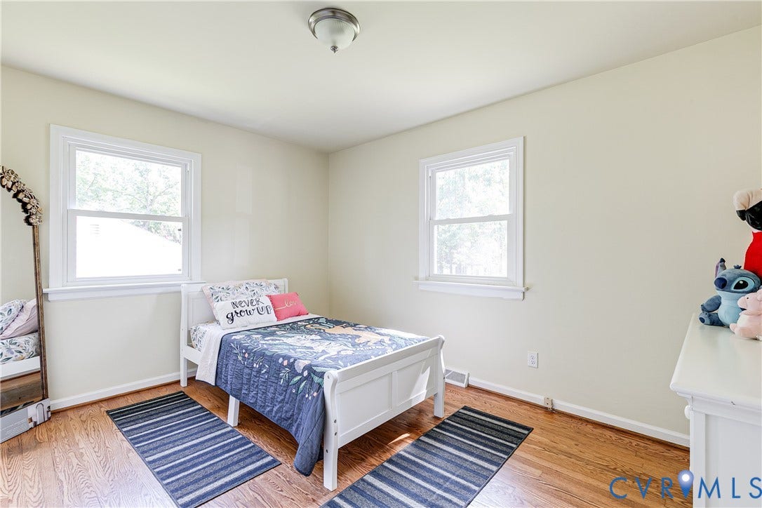 Warm-toned wood-finish flooring with white trim