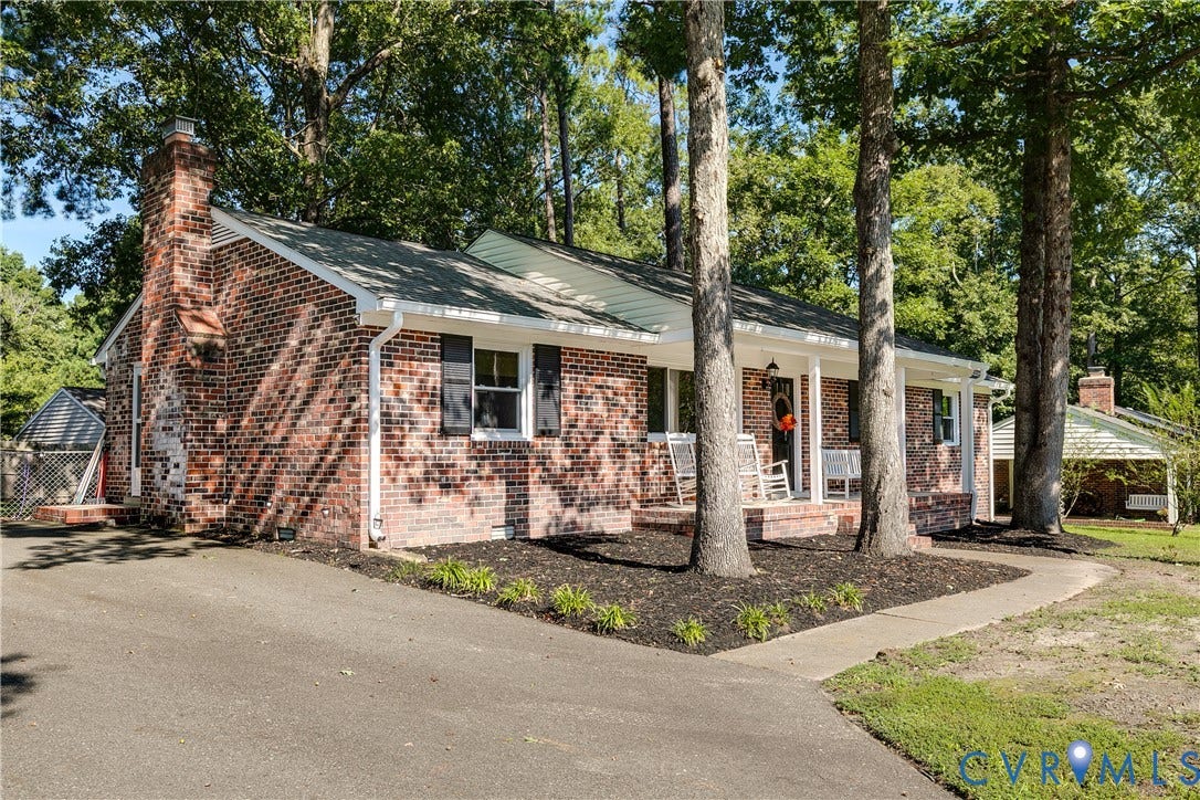 Brick exterior with a prominent chimney and black shutters