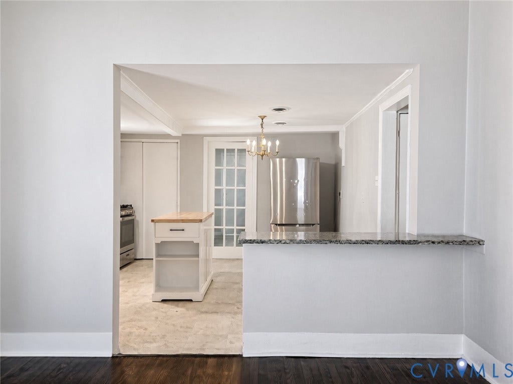 1223 Paul Street, Hillcrest, Petersburg, VA 23803 Kitchen featuring a built-in breakfast bar with stone-finish countertop, stainless steel refrigerator, and a freestanding island with wood-finish top