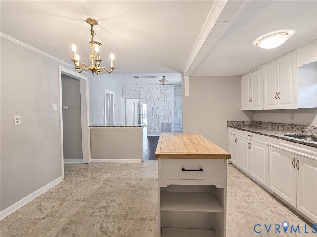 1223 Paul Street, Hillcrest, Petersburg, VA 23803 Kitchen featuring white cabinetry, wood-top island, stone-finish countertops, and an overhead chandelier