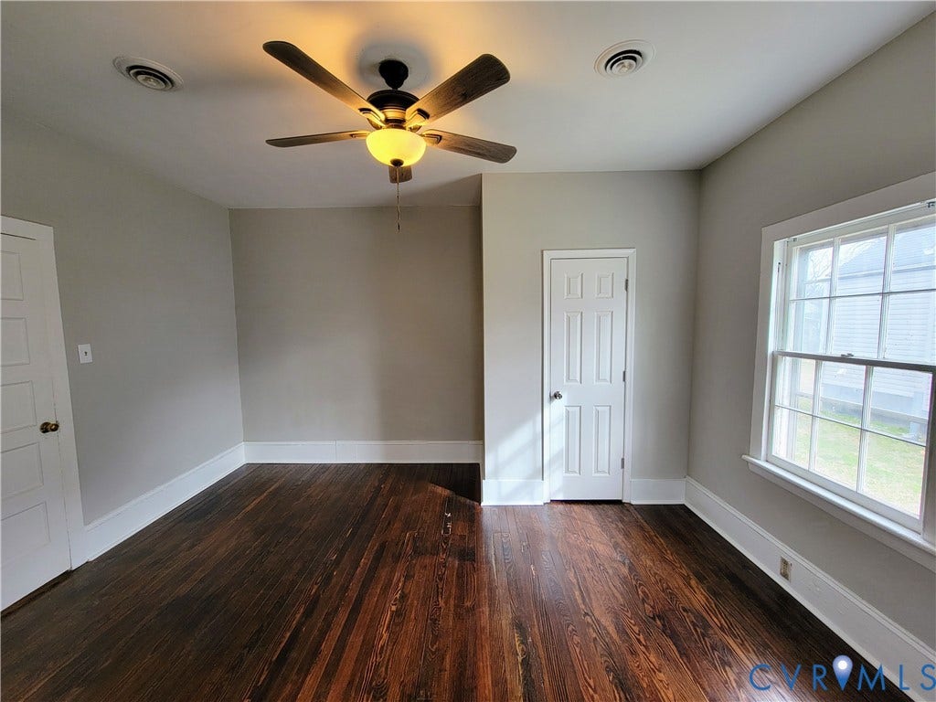 1223 Paul Street, Hillcrest, Petersburg, VA 23803 Rich wood-finish flooring, white trim, and a ceiling fan with integrated lighting