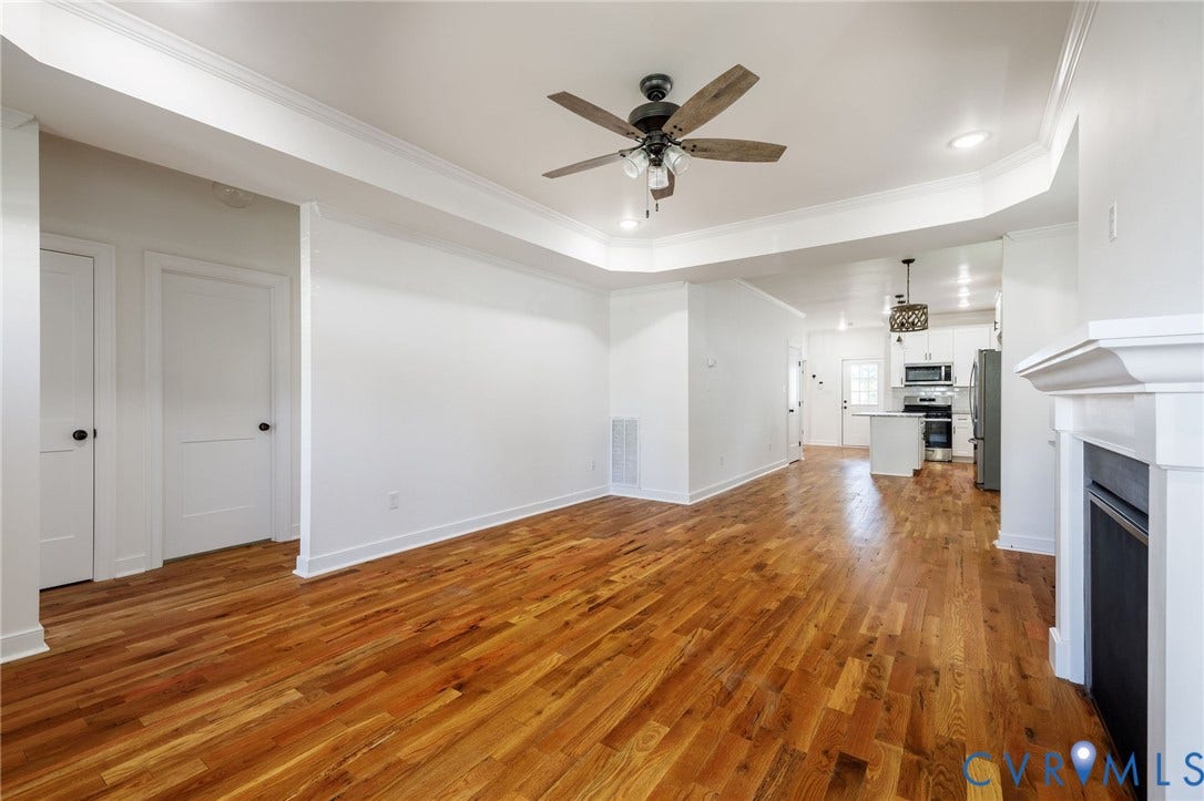 2902 Lawson Street, Richmond, VA 23224 Living area featuring wood-finish flooring, recessed lighting, crown molding, tray ceiling, and a fireplace with a white mantle