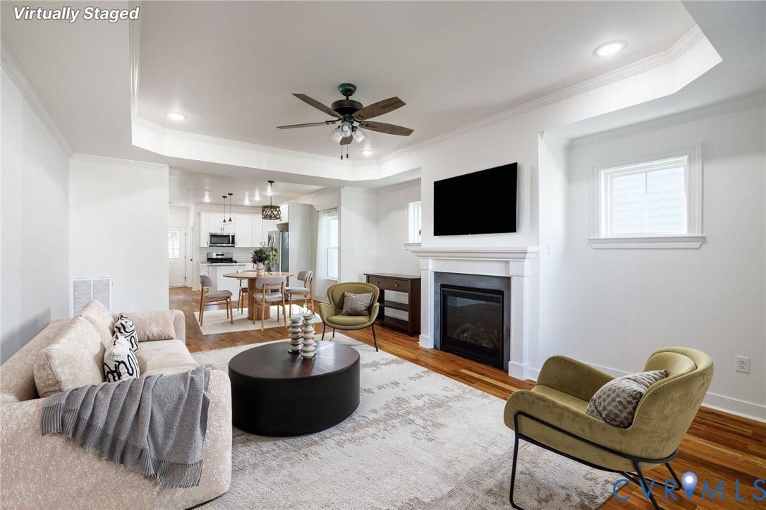 2902 Lawson Street, Richmond, VA 23224 Tray ceiling featuring recessed lighting and a ceiling fan, fireplace with a mantel, and wood-finish flooring