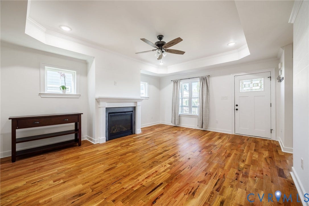 2902 Lawson Street, Richmond, VA 23224 Tray ceiling, wood-finish flooring, recessed lighting, fireplace with a decorative mantel, and an exterior entry door with glass paneling
