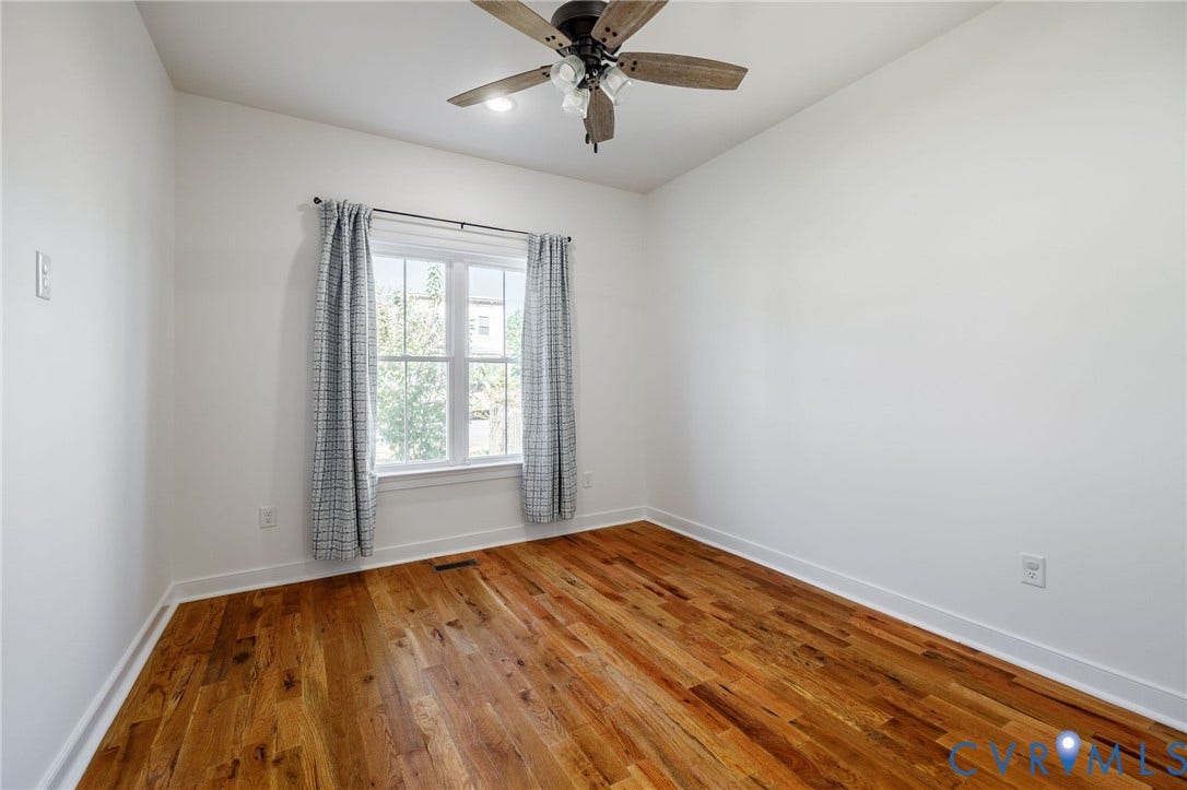 2902 Lawson Street, Richmond, VA 23224 Wood-finish flooring, neutral walls, and a ceiling fan with integrated lighting