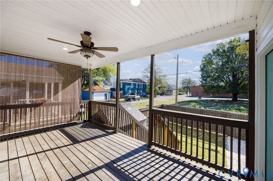 2902 Lawson Street, Richmond, VA 23224 Covered deck featuring wood-finish flooring, a ceiling fan, and dark-stained wood railings