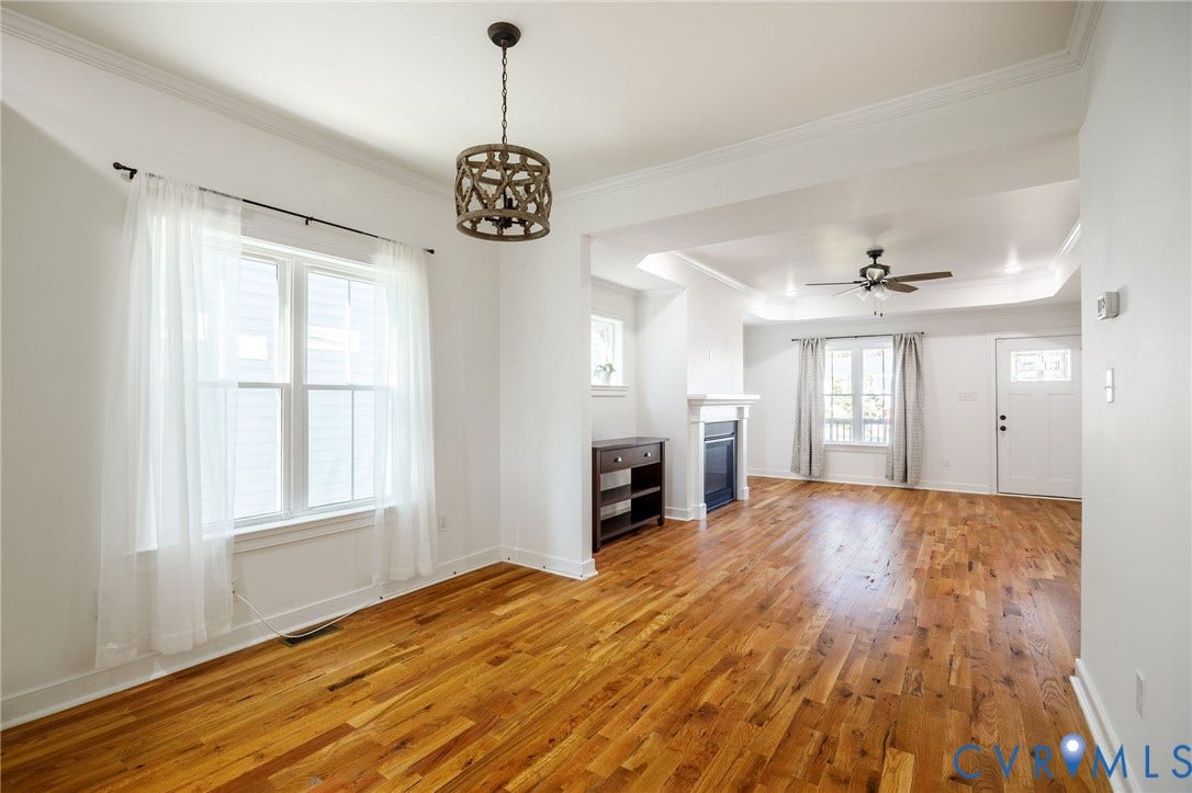 2902 Lawson Street, Richmond, VA 23224 Hardwood flooring, crown molding, decorative drum pendant lighting, fireplace with mantel, and recessed tray ceiling